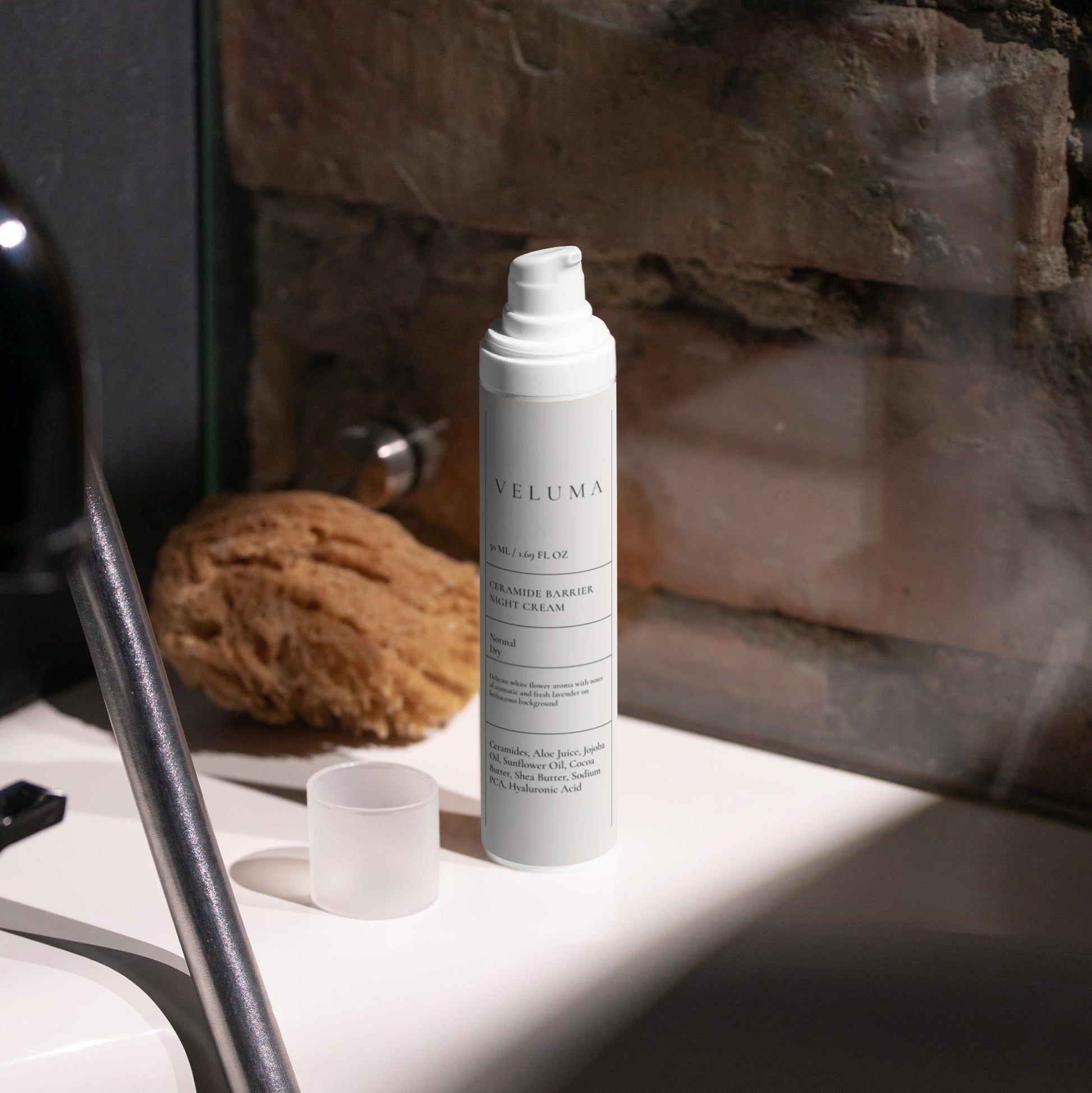 Skincare bottle on a bathroom counter with a stone wall background