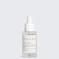 Veluma skincare serum bottle on a light gray background